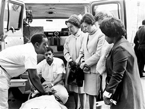 Freedom House paramedics Carl Staten, left, and Eugene Key show their skills to onlookers, from left, Mrs. Margaret Clement, Mrs. Edward Hale, Mrs. C.D. Rea and Mrs. Dorothy Williams. 