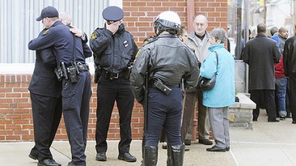 Visitation-for-a-fellow-officer.jpg Visitation for a fellow officer Police embrace outside the Winter Funeral Home in Bloomfield during visitation for fellow officer Paul J. Sciullo II.