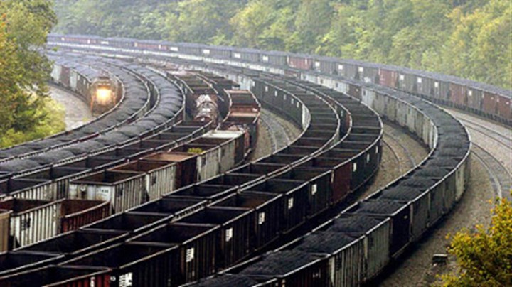 Coal train photo Railcars, some loaded with coal, others empty, line a hollow in the coal-rich region of Mingo County, W.Va.