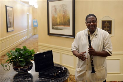 20140626MWHbellhopSunMag02-1 Darryl Cann, a bellman at the Omni William Penn Hotel in Downtown Pittsburgh, shows the Post-Gazette his clarinet during a tour of the building.