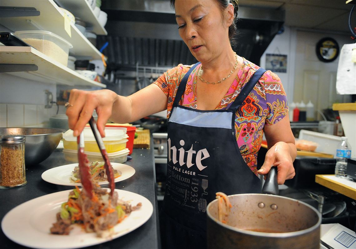 Owner Yong Kwon plates Bulgogi, a marinated beef dish, at Golden Pig, a Korean restaurant in Cecil. 
