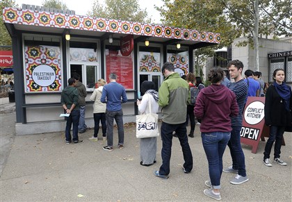 20141006radConflictKitchenLocal02-1 There were long lunch lines at the Conflict Kitchen in Schenley Plaza in Oakland on the first day of their Palestinian menu in October. 