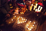  Neighbors and community members light candles in remembrance of the six people who died in a house fire in Mckeesport.