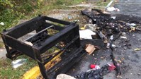  A charred piece of furniture shows part of the damage left behind in some of Morgantown, W.Va.'s streets during Saturday's riots at WVU.