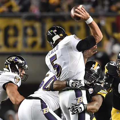 20141102pdSteelersSports05-5 James Harrison pressures Raven quarterback Joe Flacco in the first half of a game in November at Heinz Field.