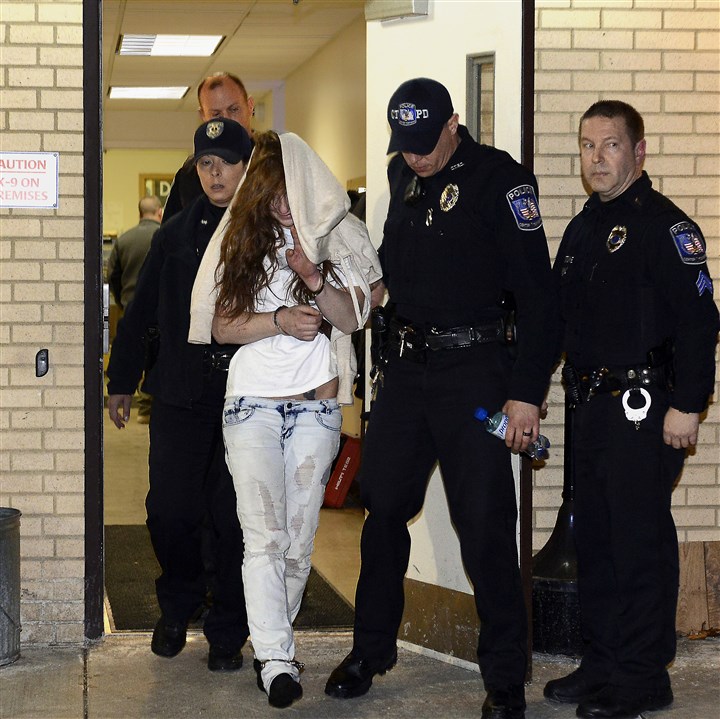 20150114rldRimer01 Roxanne Rimer is escorted out of the Center Twp. Police Dept. 