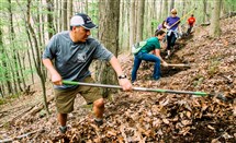  Abraham Martinez and other volunteers with the Hollow Oak Land Trust work on a section of the trail that will connect Moon Township Community Park with the Montour Woods Trail last year. The land trust will mark its 25th anniversary next month with a Brewhaha.