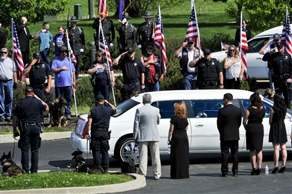 20150509EslaryFuneral03 Mourners line the entrance to Holy Trinity Church as relatives of Ligonier Township police Lt. Eric A. Eslary arrive for his funeral in May.