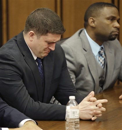 APTOPIX Cleveland Police Shooting Michael Brelo weeps as he hears the verdict in his trial Saturday, May 23, 2015, in Cleveland. Brelo, a patrolman charged in the shooting deaths of two unarmed suspects during a 137-shot barrage of gunfire was acquitted Saturday in a case that helped prompt the U.S. Department of Justice determine the city police department had a history of using excessive force and violating civil rights. 