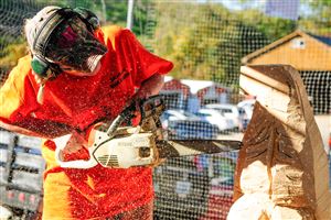  Barb Giegucz of Cranberry carves an eagle out of a log at Soergel Orchards. Ms. Giegucz has been carving for over two years. It will take her several hours to finish this carving. After carving, she will burn the sculpture, stain and weather-proof it before selling the piece.