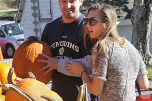  Ben Capo of Beaver, left, listens to his girlfriend Lauren Posteraro of Marshall as they select pumpkins at Shenot Farm in Marshall. 