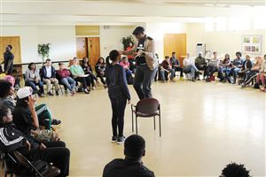  Gary Kinte Perry, an associate professor of sociology at the University of Seattle, standing on a chair, and Charis Allen of Penn Hills discuss the definition of racism and the history of racial categorizations in the U.S. during a workshop at the Bethel AME Church in the Hill District.