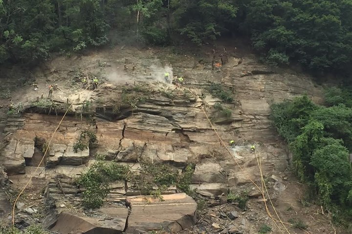 Norfolk Southern will use dynamite to remove rocks above West Carson Street