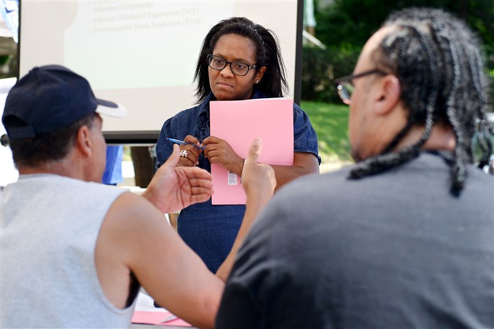 BULLDOG - 20160611ppFocus1LOC Tiffany Kinney of the Hill District leads a break-out session in June at the first meeting of a project to fight long-term trauma in the 2900 block of Webster Avenue.