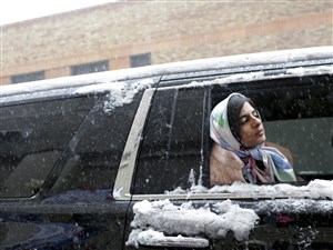 Haya Maraka, a fashion stylist, waits while making her way to the Erin Fetherston show at Skylight Clarkson Square during New York Fashion Week on Thursday.