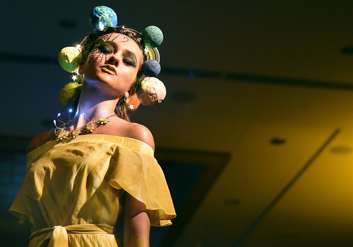 A model pauses on the runway, her dress and headpiece inspired by the sun, at the Ecolution Fashion Show on April 20, 2017 at the Fairmont Pittsburgh hotel, Downtown.
