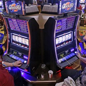 In this July 1, 2013 file photo, casino patrons play some of the 600 slot machines at the Lady Luck Casino at Nemacolin in Farmington, Pa.