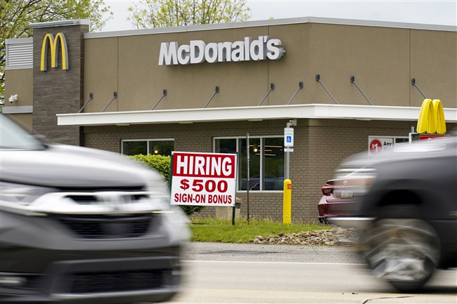  A hiring sign offers a $500 bonus outside a McDonald's restaurant, in Cranberry Township, Butler County, Pa., Wednesday, May 5, 2021. (AP Photo/Keith Srakocic)