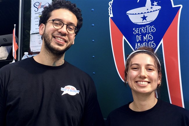  Secretos de mis Abuelos food truck owner Felipe Crespo and team member Elizabeth Lusardi on Thursday in Beechview. The truck serves Puerto Rican food featuring recipes Mr. Crespo learned from his grandmother. 
