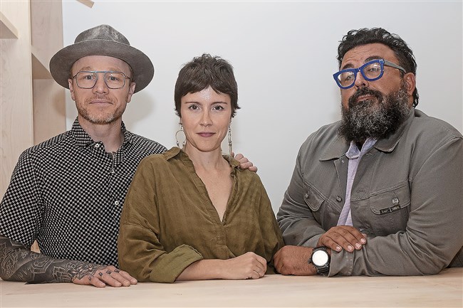  Kevin, left, and Meg Sousa and longtime friend and collaborator Chris Clark in Mount Oliver Bodega, a wine bar and gourmet pizza restaurant that is under construction. 
