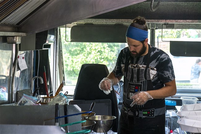  Owner David Sciulli prepares a dish in Old Ben's Cantina food truck in Mellon Park on Sept. 12, 2021.