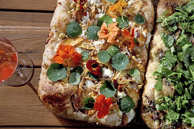  The menu at Mount Oliver Bodega will include a green pizza, right, with pesto, chicken of the woods mushrooms, arugula, ricotta and pecorino  and a white pizza with garlic confit, ricotta, pink peppercorn, peach, corn and honey. 