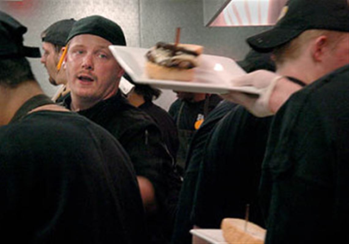 Chef Brandon King mixes in the kitchen at Jerome Bettis Grille 36.