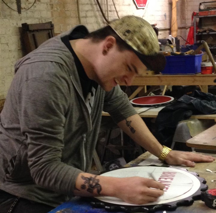 walkabout0229 Chase McBryde, owner of Reanimated in Pittsburgh, paints a sign for a new Allentown business at Industry on Industry, a new incubator for artists and makers.