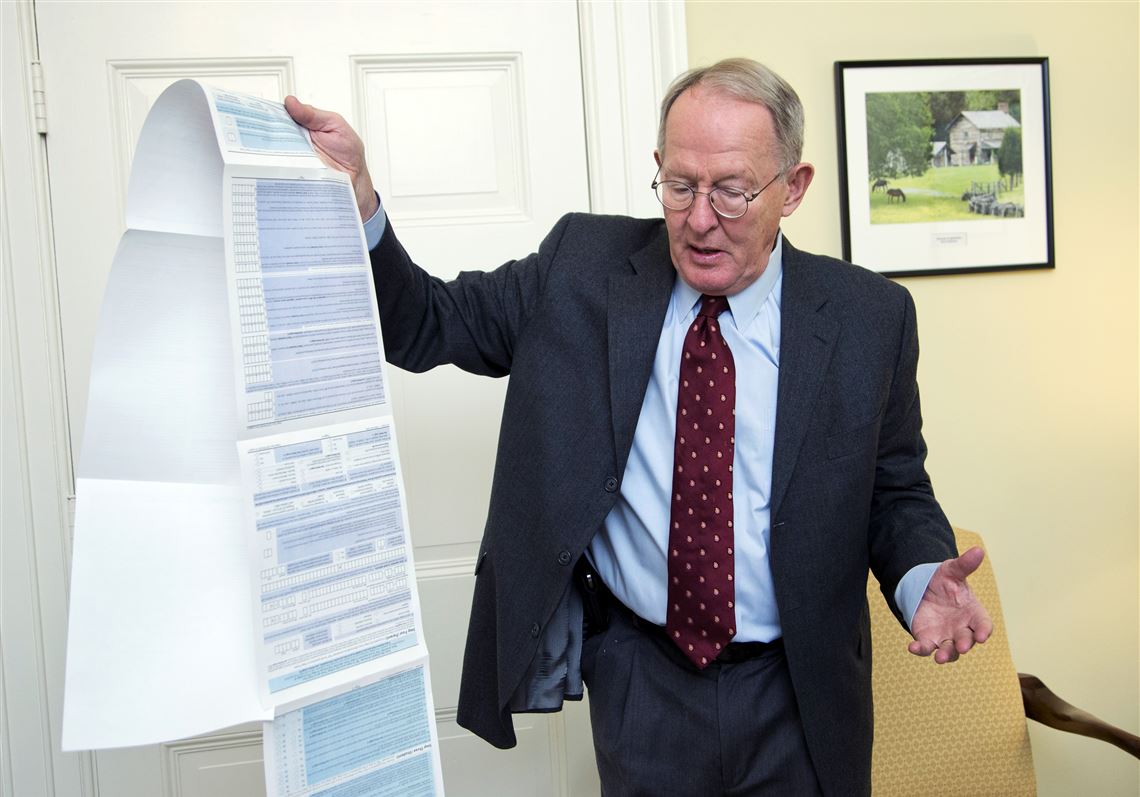 Sen. Lamar Alexander, R-Tenn., holding the Free Application for Federal Student Aid (FAFSA) form, during an interview on Capitol Hill in Washington.    