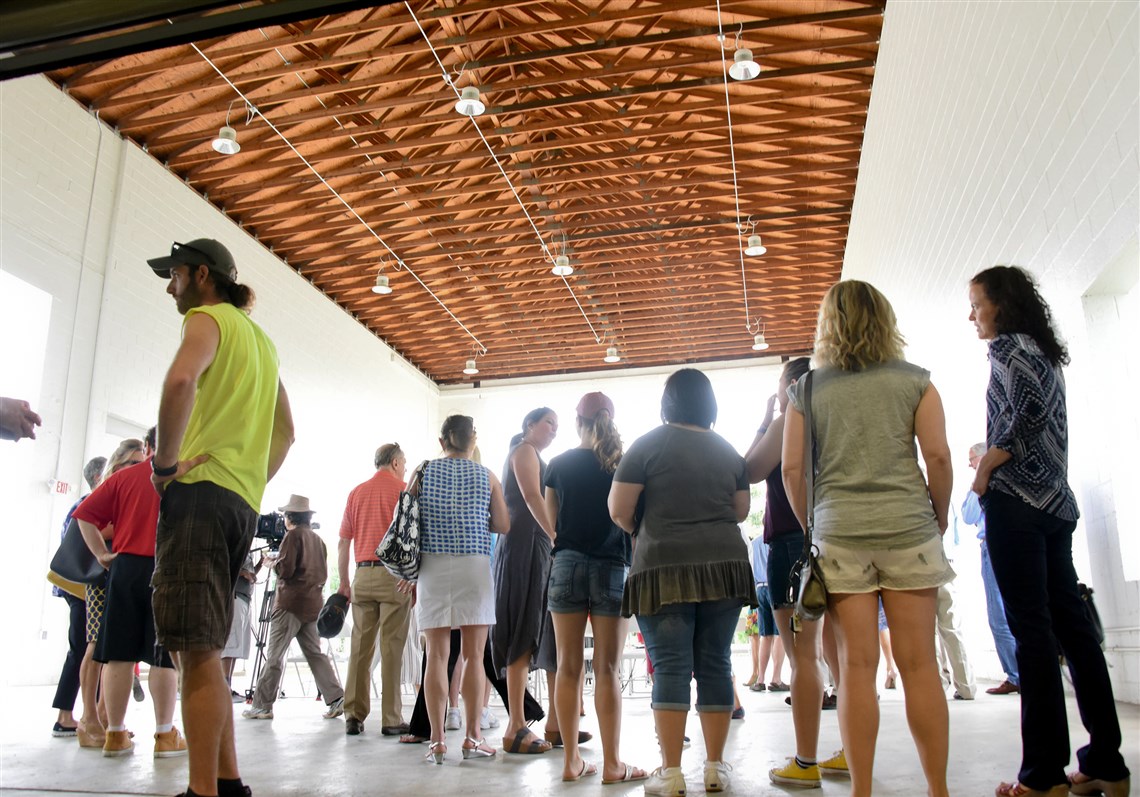 People gather in the new welcome center at the Aspinwall Riverfront Park. The center was built from a former boat-storage bay.