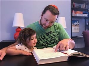 Chris Hall, the head of adult education at Beth Shalom, studies with his daughter Ada. Since he converted to Judaism at a conservative synagogue as an adult, his religious practice is central to his life. 