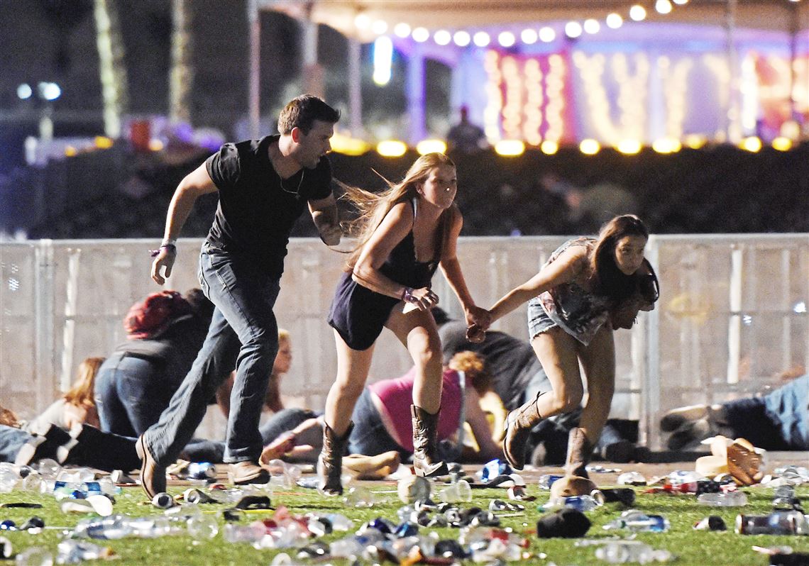 People run from the Route 91 Harvest country music festival after a gunman opened fire on the concert from a nearby hotel.