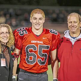 This Oct. 31, 2014, photo shows Timothy Piazza with his parents, Evelyn and James Piazza, during Hunterdon Central Regional High School football’s Senior Night in Flemington, N.J.   (Patrick Carns via AP)