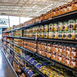 Several types of canned and bagged beans line the shelves in the new market area at the Greater Pittsburgh Community Food Bank in Duquesne on Thursday, Sept. 28, 2023. 
