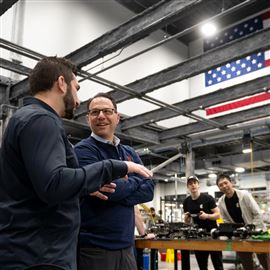Gov. Josh Shapiro speaks with Jake Loosararian, co-founder and CEO of Gecko Robotics, at the startup's North Shore headquarters on Thursday. Mr. Shapiro visited the wall-scaling robot builder as part of his bid for state funding for robotics and tech, one pillar of his 10-year economic development plan.