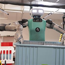 An Agility Robotics Digit 6 robot moves product containers in a simulated shipping warehouse scenario at the company’s headquarters in Lawrenceville on Tuesday, August 27, 2024. 