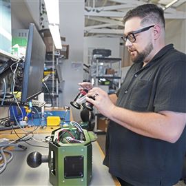 Bloomfield robotics company test engineer Anthony Theofiledes works on one of the companies robotic camera systems at the company office in Lawrenceville on Tuesday, August 27, 2024. 