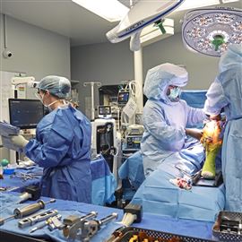 UPMC surgeon Dr. Ken Urish, right, and his team perform a robotics assisted knee replacement at UPMC Magee-Womens Hospital in Oakland Friday, Oct. 25, 2024. 