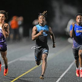 Woodland Hills' Scoop Smith, middle, runs a 10.78 to win the boys 100-meter dash during the Baldwin Invitational Track Meet at Baldwin High School on Friday May 2, 2025. 